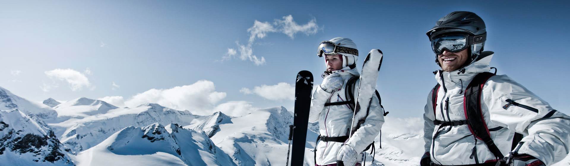 Two skiers on the mountain at perfect weather conditions