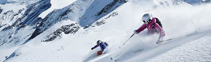 Two skiers in deep snow off piste